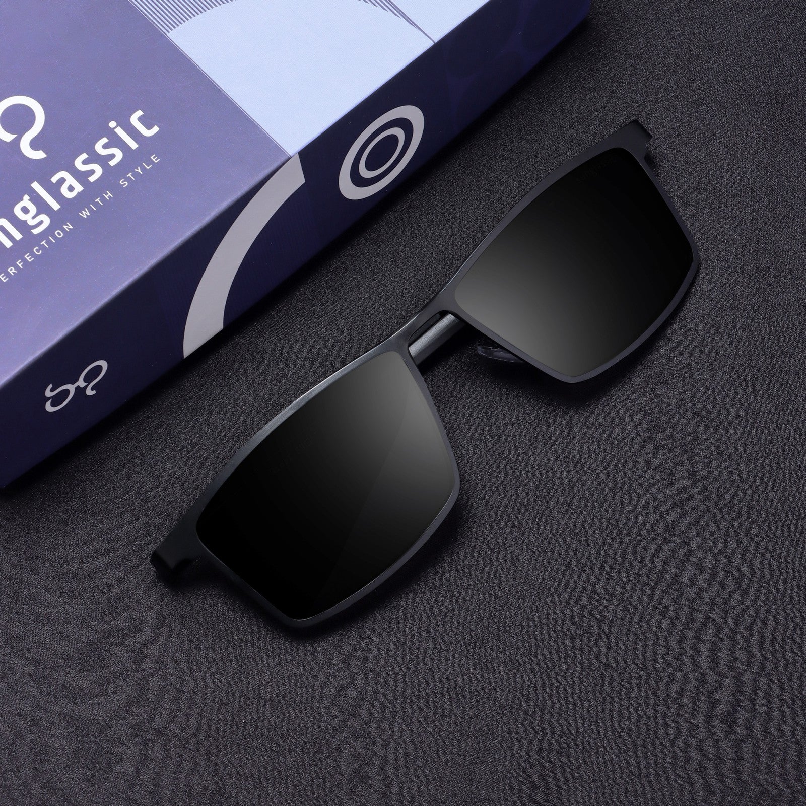 Flat lay top-down of RideX black sunglasses with lens and case