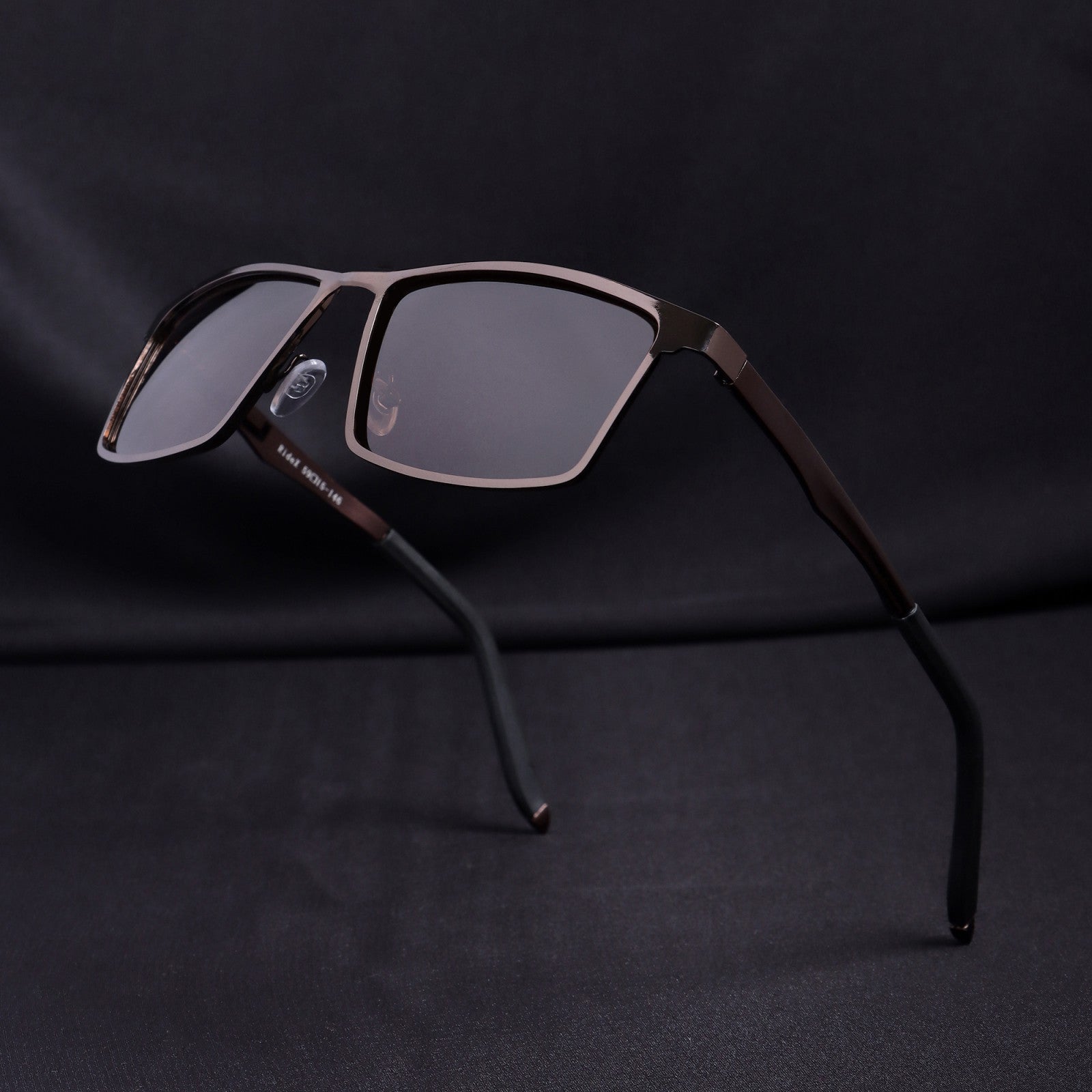 Floating view of RideX brown sunglasses showing lens and hinge details