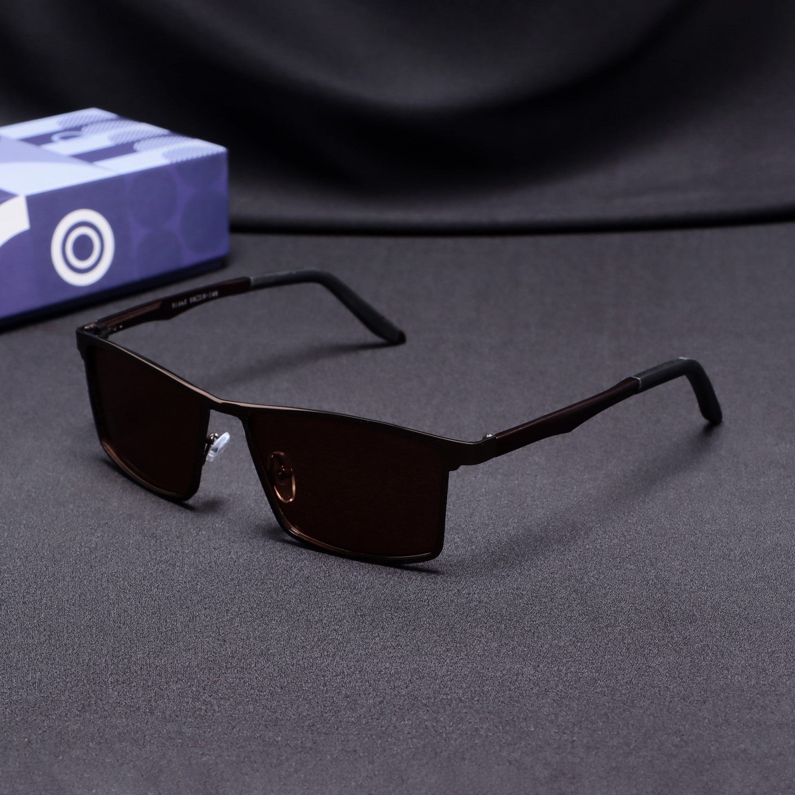 Side angle of RideX brown metal sunglasses with brown polarized lenses