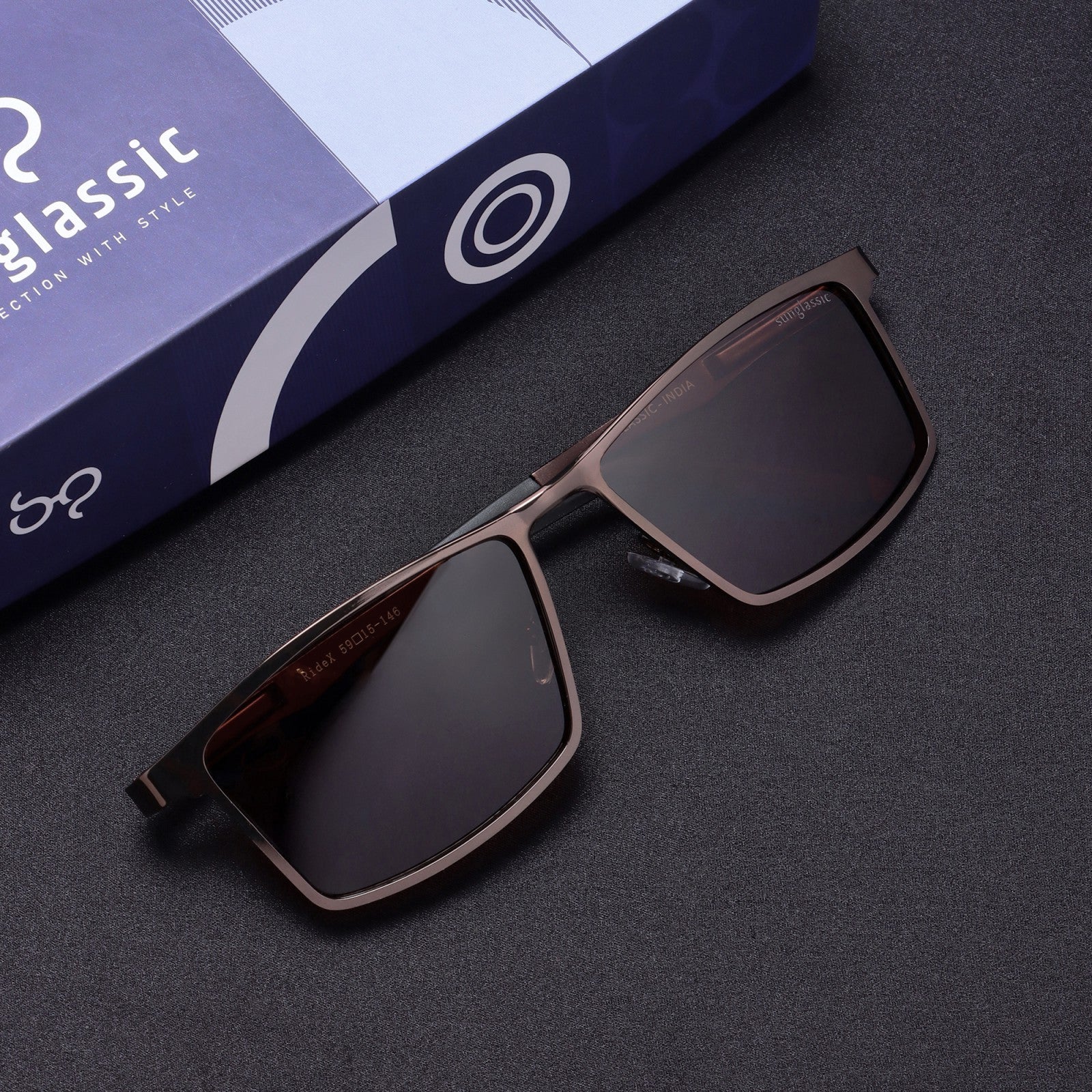 Top-down flat lay of RideX brown rectangle sunglasses