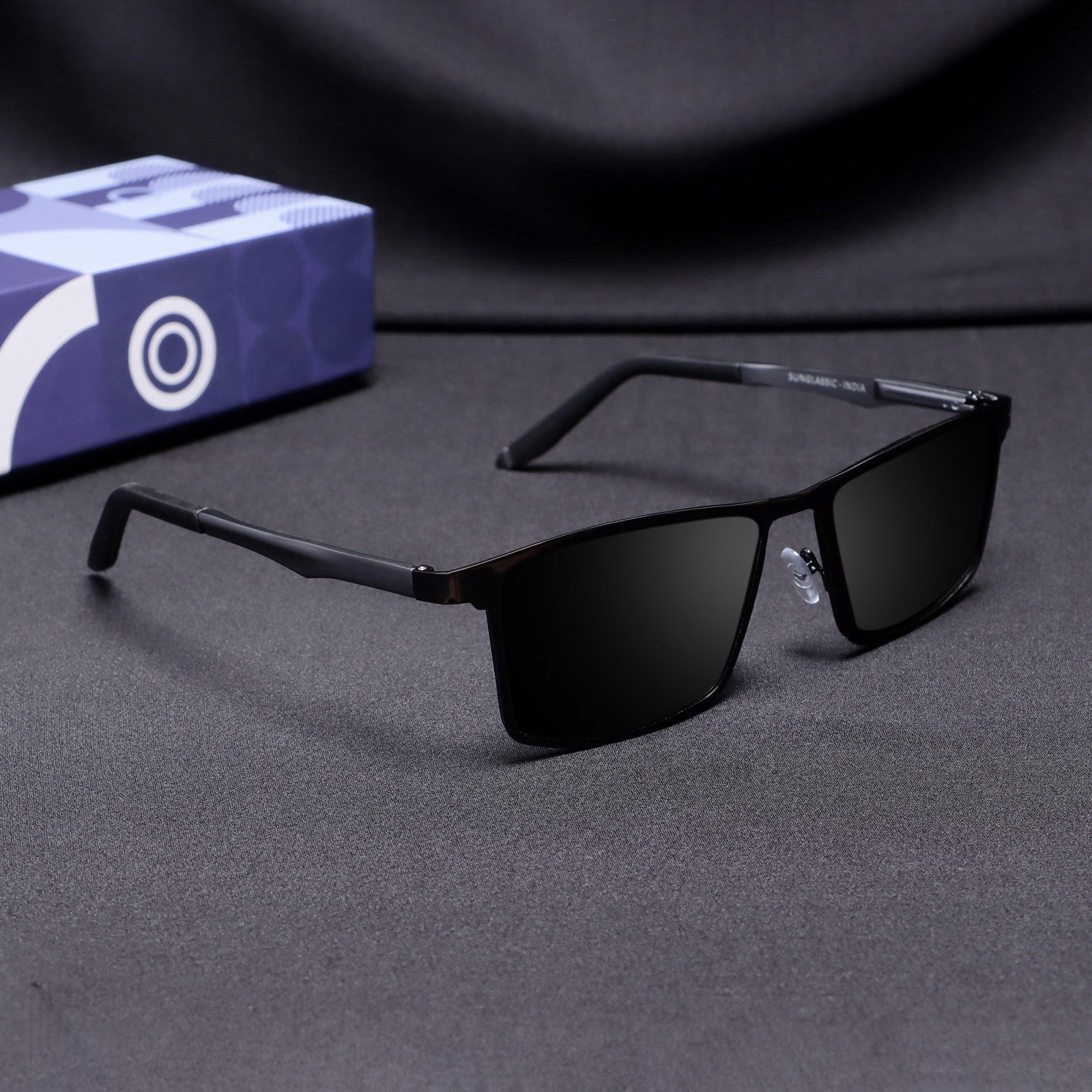 Side angle view of RideX gray metal sunglasses with black polarized lenses