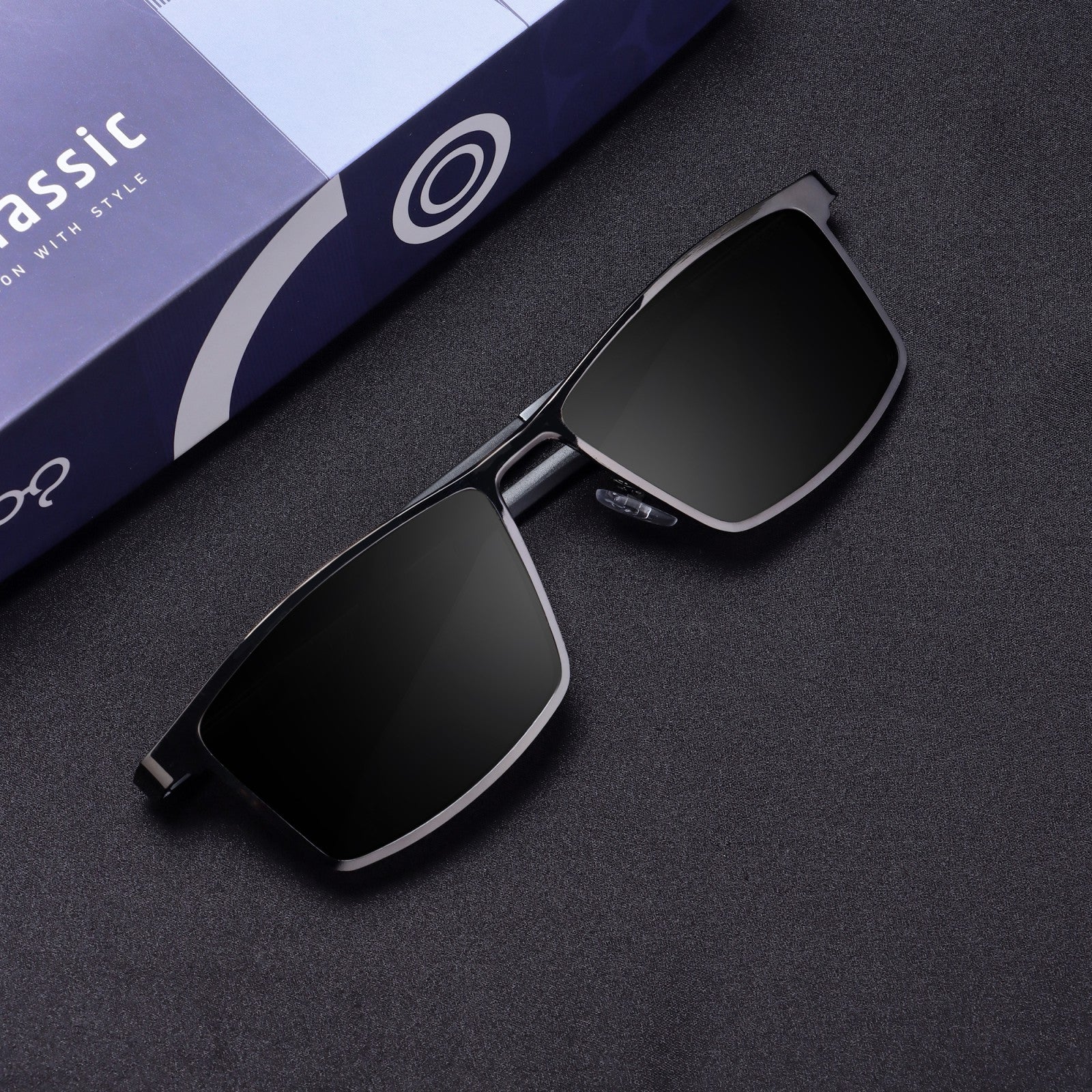 Flat lay top-down of RideX gray black sunglasses with case