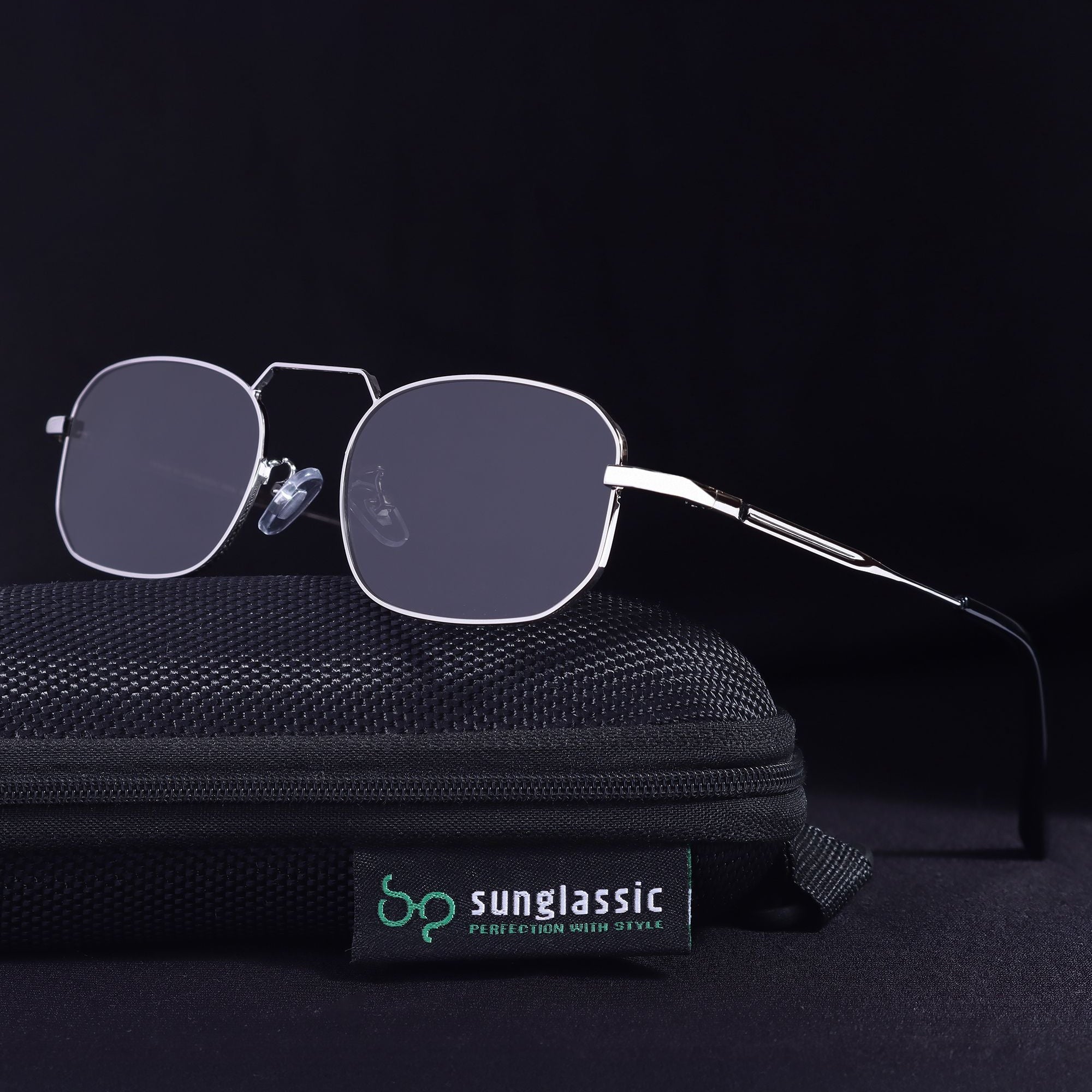Sunglasses on a black textured surface with 'Sunglassic' branding.