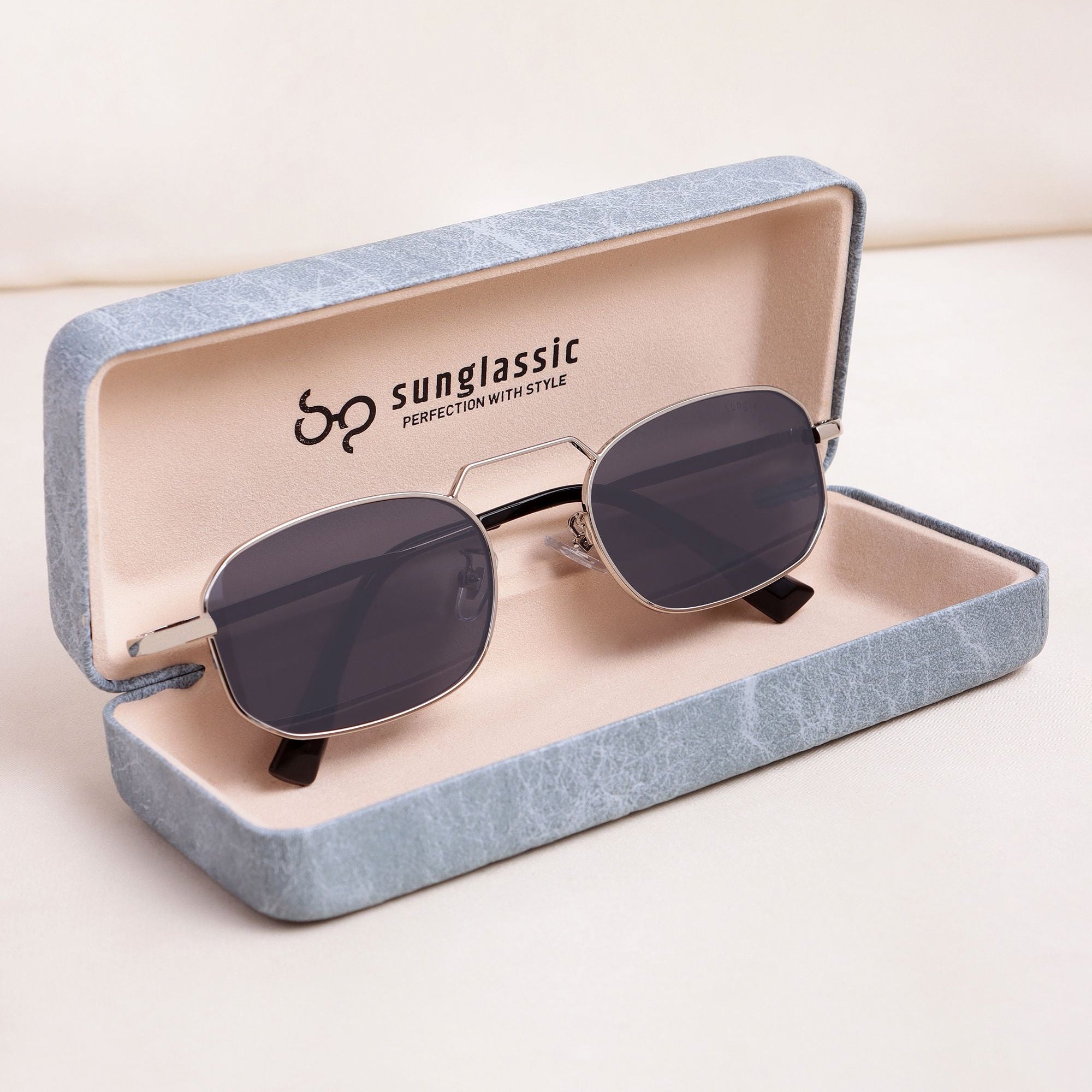 Sunglasses in an open blue Sunglassic case on a light background
