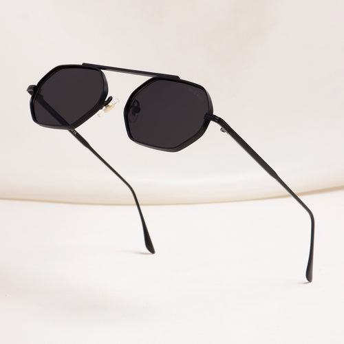 Black sunglasses with a hexagonal frame on a light beige background
