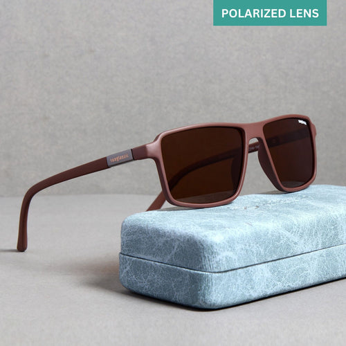 A pair of brown polarized rectangle sunglasses resting on a blue textured surface, with a metal case and a cleaning cloth beside them.