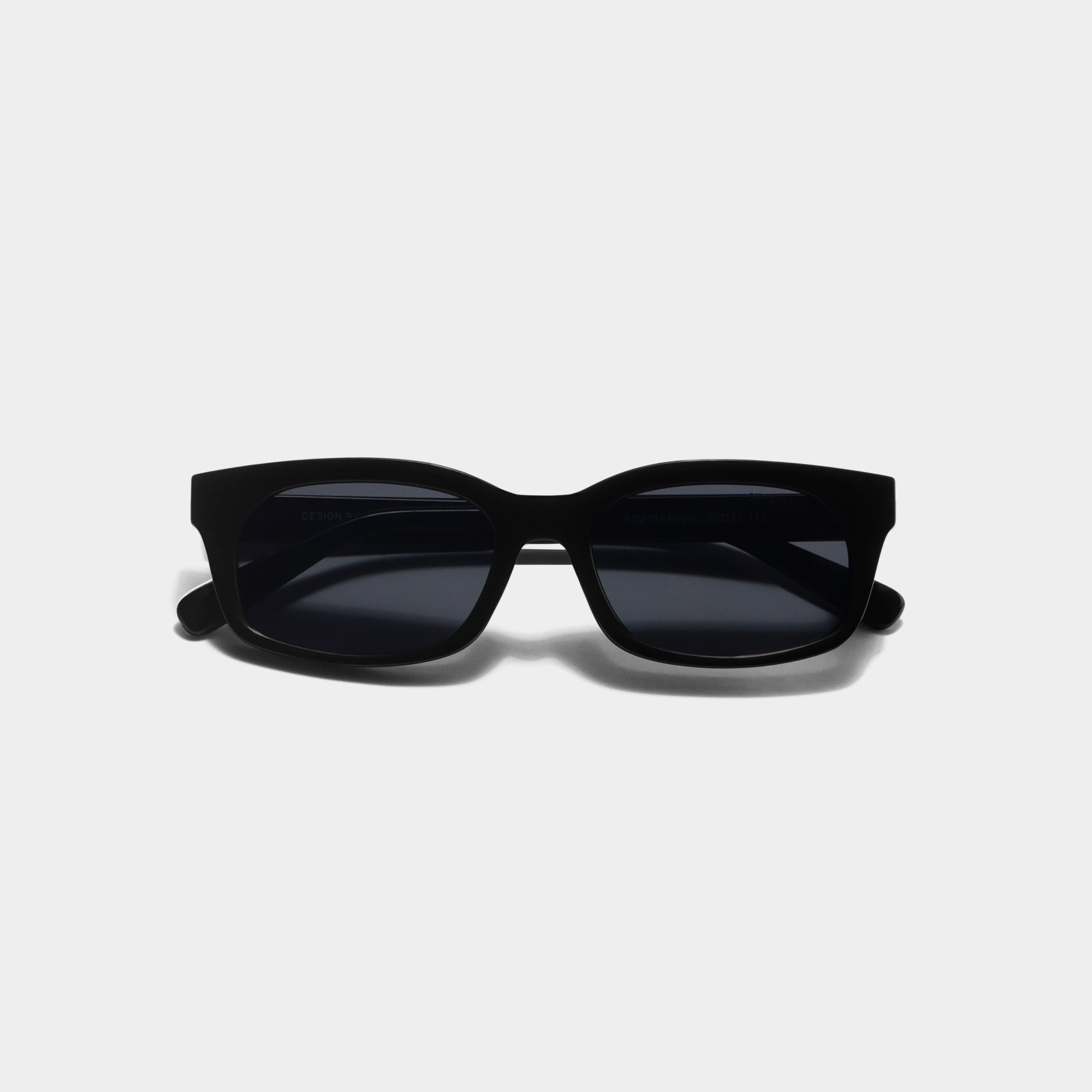 Black cat-eye sunglasses with dark lenses, shown from the front on a light gray background.