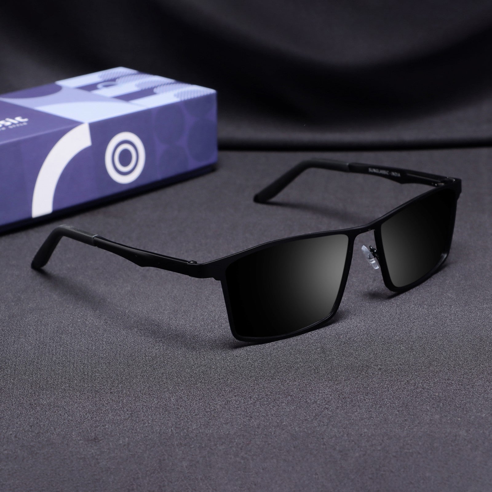 Side angle view of RideX black sunglasses with polarized black lenses