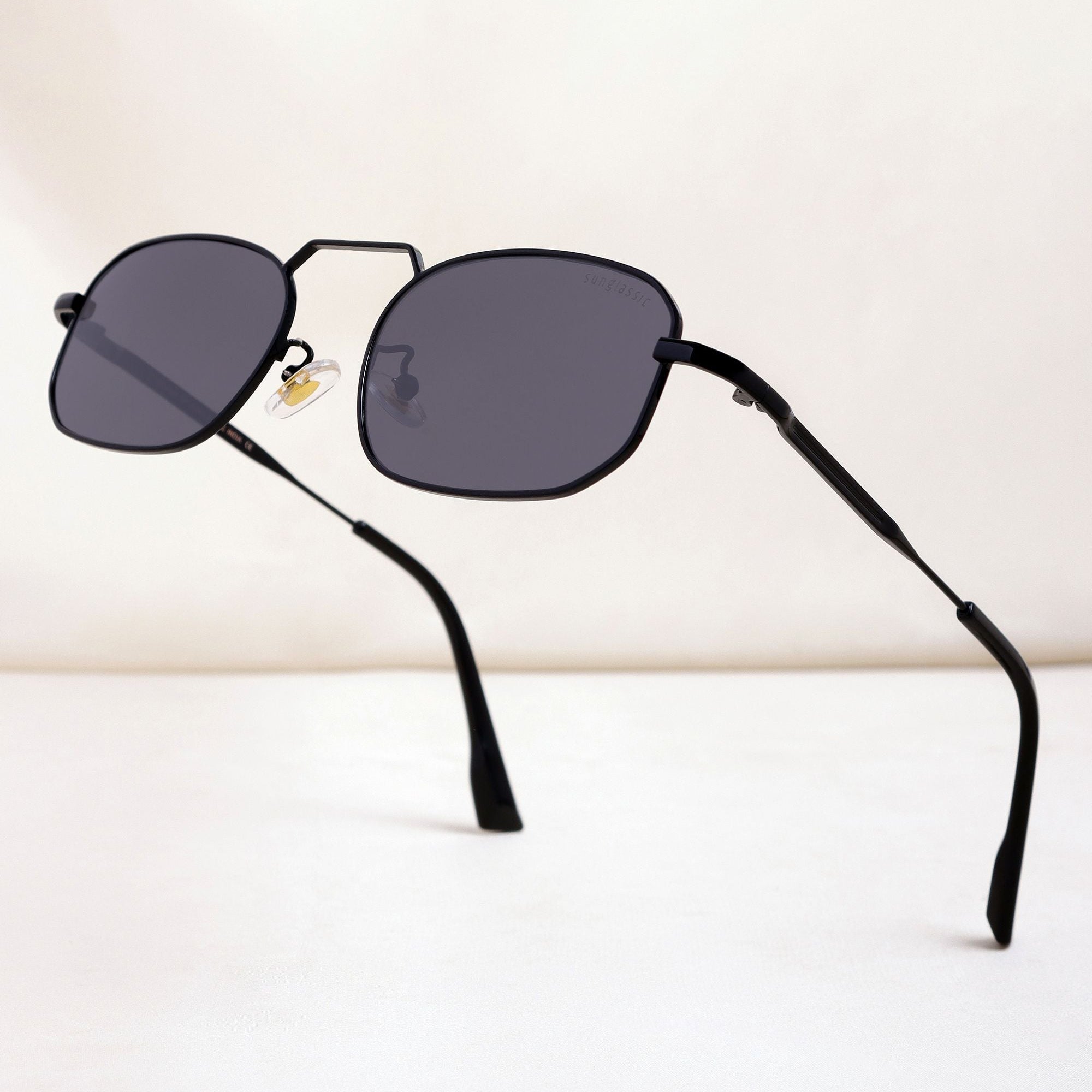 Black sunglasses with dark lenses on a white background