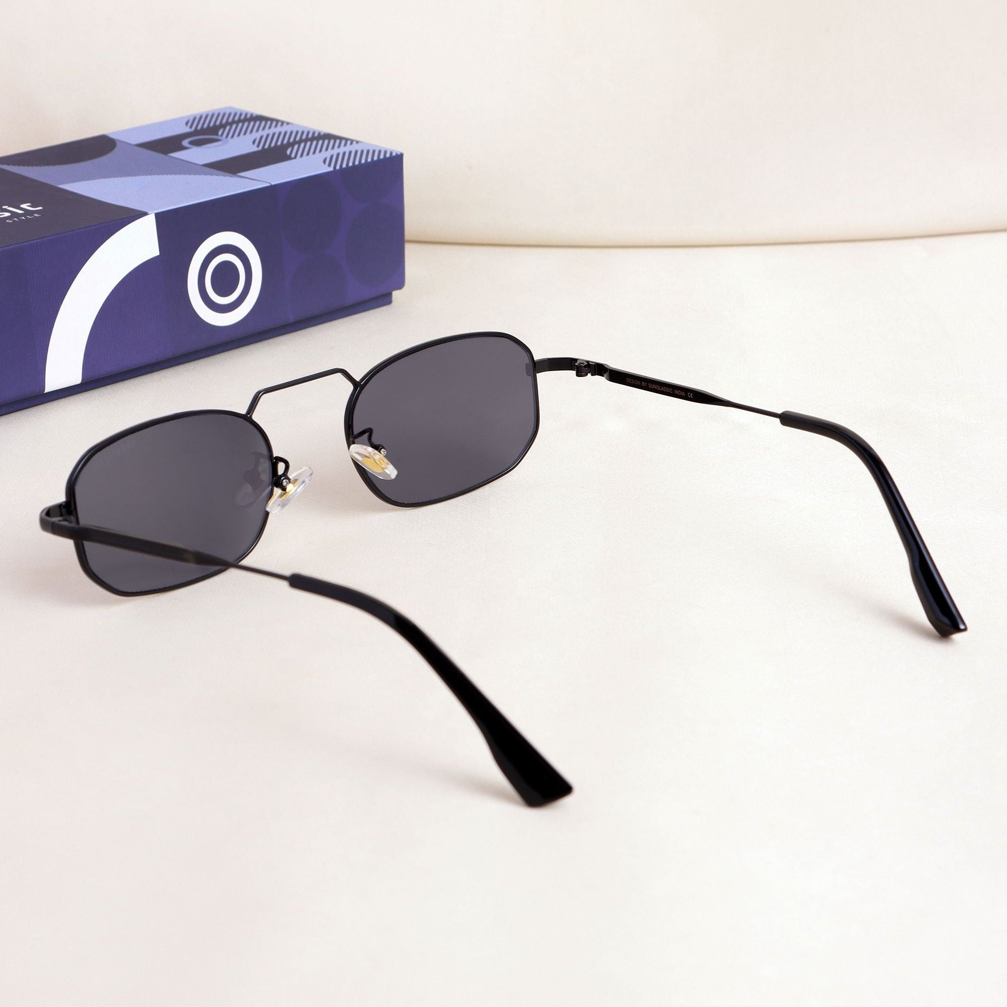 Black sunglasses with a blue box on a white background