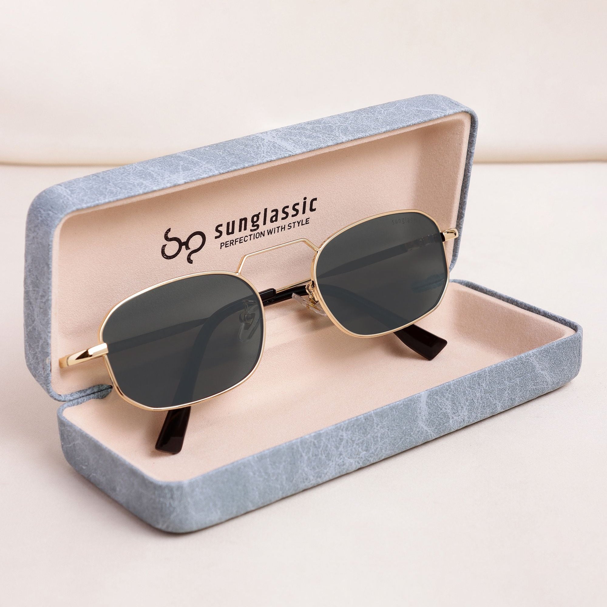 Sunglasses in a 'sunglassic' branded case on a light background
