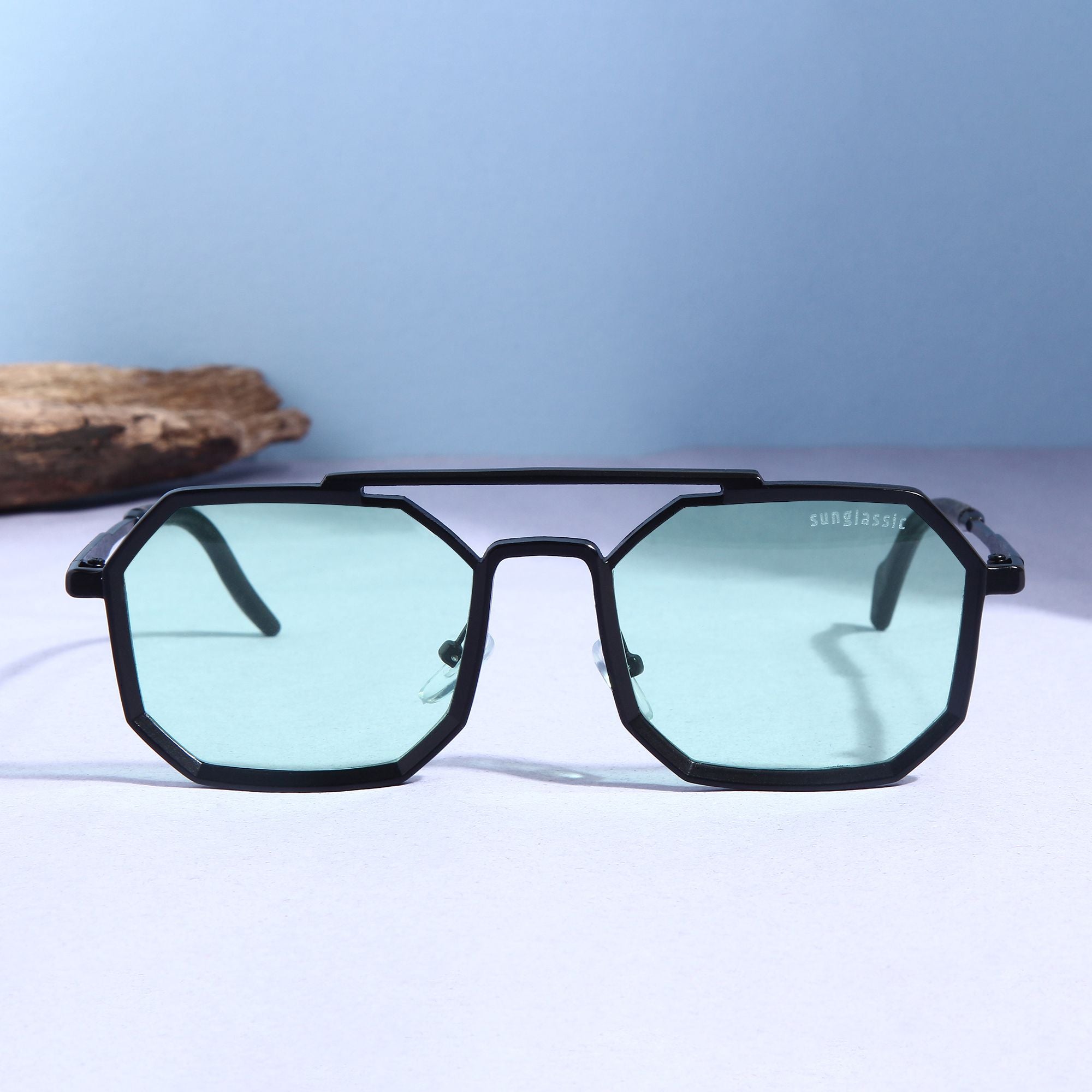 Stylish black sunglasses with green lenses.