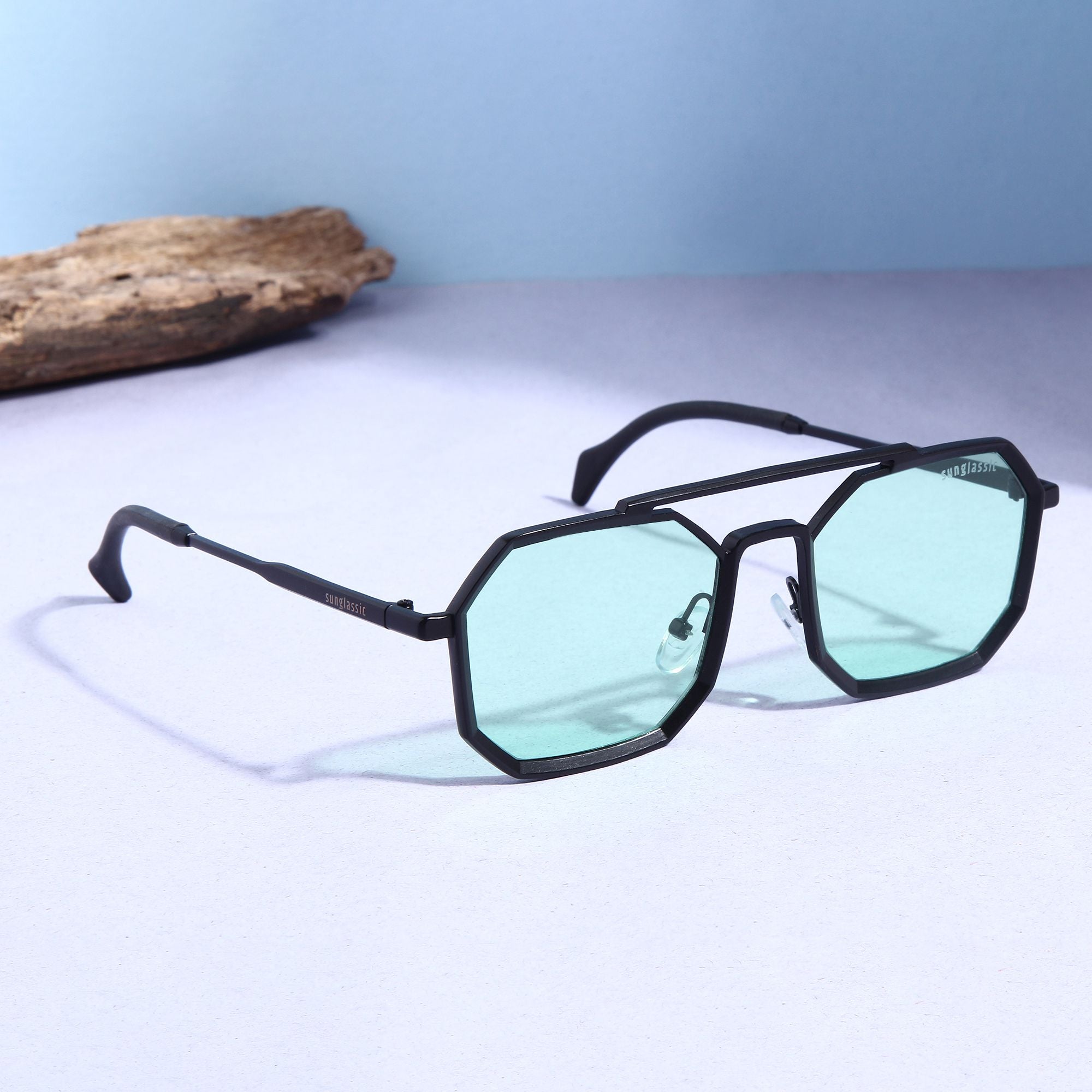 Sunglasses with a stylish octagonal shape and green lenses.
