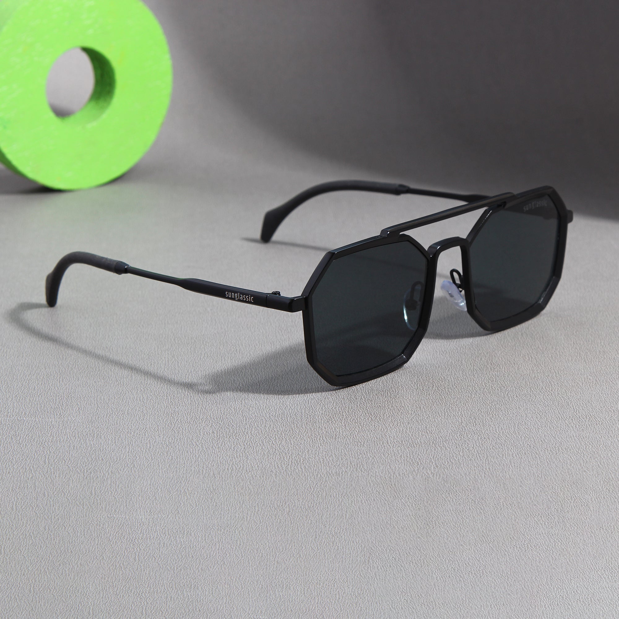 Sunglasses with a stylish octagonal shape and black lenses.